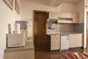 a kitchen with a refrigerator and a stove top oven at TATRYSTAY Apartment C3 in Veľká Lomnica