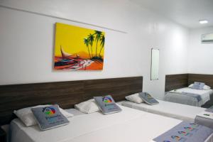 Ένα ή περισσότερα κρεβάτια σε δωμάτιο στο Pousada Arco Iris Fortaleza