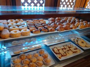 a display case filled with lots of different types of donuts at Parador de Guadalupe in Guadalupe