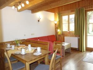 a living room with a table and a couch at Doblerhof in Höslwang