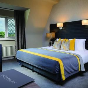A bed or beds in a room at The Gleneagle Hotel & Apartments