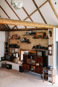 a living room with a brick wall with a shelf at Sura din Joseni in Porumbacu de Sus