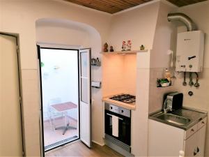 a small kitchen with a sink and a stove at Apartment in the Castle of S. Jorge in Lisbon