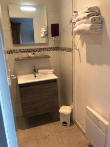 a bathroom with a sink and a mirror at The Originals City, Hôtel La Cour Carrée, EU in Eu