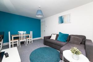 a living room with a couch and a table at Eglesfield 3 Bedroom South Shields in South Shields