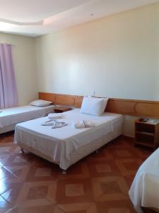 a hotel room with two beds at Hotel Litoral in Aracaju