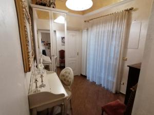 a bathroom with a white sink and a mirror at A Casa di Mamma Rita in Chieti