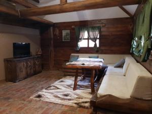 a living room with a couch and a table at Apartman Trebević Dolina mira in Pale