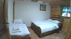 a bedroom with two beds and a window at Apartman Trebević Dolina mira in Pale