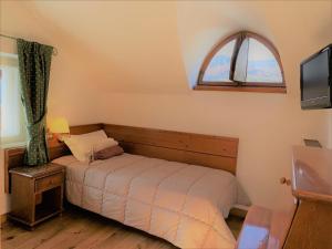 Postel nebo postele na pokoji v ubytování Hotel Serena Cortina