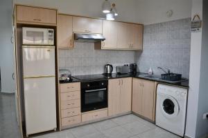 a kitchen with a white refrigerator and a dishwasher at Queens Gardens - Kato Paphos - next to Kings Ave Mall --- by Yiota in Paphos City