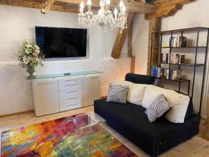 a living room with a couch and a tv at Private Luxury Chalet in Siegsdorf