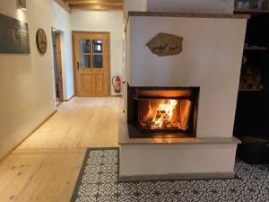 a fireplace in the middle of a living room at Private Luxury Chalet in Siegsdorf