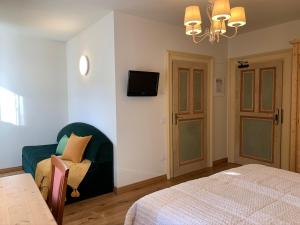 Postel nebo postele na pokoji v ubytování Hotel Serena Cortina