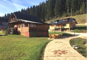 a log cabin with a path in front of it at Apartman Trebević Dolina mira in Pale
