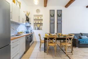 a kitchen and dining room with a table and chairs at MY CASA - GALLIENI in Nice