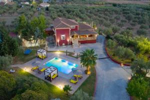 an aerial view of a house with a swimming pool at Luxury Villa Froso in Ambelókipoi