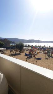 a view of a beach with tables and chairs at 3 bedrooms appartement with sea view furnished terrace and wifi at Nigran in Nigrán