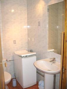a bathroom with a sink and a toilet and a mirror at Maison de charme à Saint-Laurent-la-Roche avec jardin clôturé in Saint-Laurent-la-Roche +12 photos