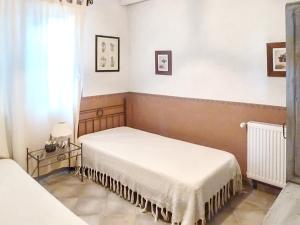 a bedroom with two beds and a window at Maison charmante à Oppède avec vue sur la montagne in Oppède +12 photos