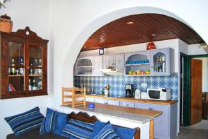 a kitchen with a table and a counter top at 5 bedrooms villa at Limnos 250 m away from the beach with sea view enclosed garden and wifi in Lemnos