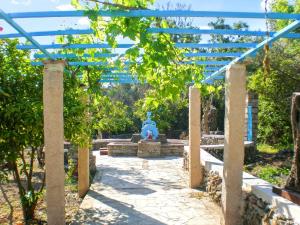 a garden with a blue fountain in the middle at 5 bedrooms villa at Limnos 250 m away from the beach with sea view enclosed garden and wifi in Lemnos