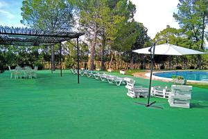 a group of chairs and an umbrella next to a pool at Spacious Villa with Private Pool, Villafranca De Los Caballeros in Villafranca de los Caballeros