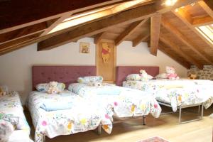 a bedroom with three beds with teddy bears on them at Charming House in La Cavada with Jacuzzi in La Cavada