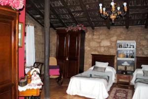 a bedroom with two beds and a chandelier at Cosy House in La Sabinita with Mountain View in La Sabinita