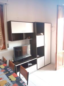 a living room with a tv and a entertainment center at Charming house with sea view in Contrada Termini in Casalbordino