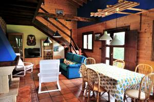 a living room with a table and a blue couch at Charming house in Albuerne with fenced garden in Albuerne