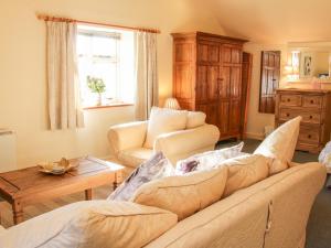 a living room with a couch and a table at Stiperstones View in Shrewsbury