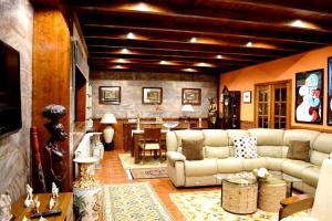 a living room with a couch and a table at Spacious Villa with Private Pool in Oliveira de Azeméis in Oliveira de Azemeis