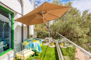 une terrasse avec une table et un parasol dans l'établissement 2 bedrooms house with wifi at Temisas Temisas 35118 Aguimes, à Temisas