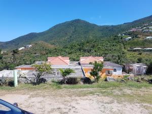 a group of houses on the side of a mountain at One bedroom appartement with furnished garden and wifi at La Savane 2 km away from the beach in Happy Bay