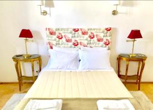 a bedroom with a bed with two side tables at 2 bedrooms appartement at Praia do Ribatejo 200 m away from the beach with lake view enclosed garden and wifi in Praia do Ribatejo