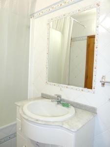 a bathroom with a sink and a mirror at 2 bedrooms house at Vila Nova de Cacela 300 m away from the beach with enclosed garden and wifi in Vila Nova De Cacela