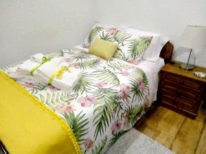 a bedroom with a bed with pink and green flowers at Paradisiacal Villa in Lousada with Private Pool in Lousada +29 photos