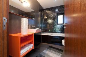 a bathroom with a sink and a toilet and a mirror at Elegant Villa Near Vieira do Minho with Pool in Vieira do Minho +48 photos