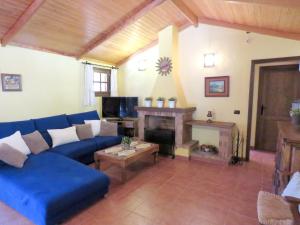 a living room with a blue couch and a fireplace at Cozy villa in San Bartolomé, 130 m², pool in San Bartolomé de Tirajana