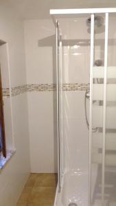 a shower with a glass door in a bathroom at 3 bedrooms house with garden at Isongo in Isongo