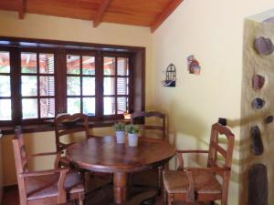 a dining room with a wooden table and chairs at One bedroom villa with enclosed garden and wifi at San Bartolome de Tirajana in San Bartolomé