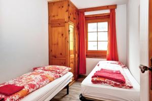 a bedroom with two beds and a window at Comfortable Apartment in Livigno with Balcony in Livigno +12 photos