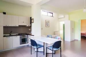 a kitchen with a table and chairs in a room at Welcoming apartment in Nicolosi with included parking in Nicolosi