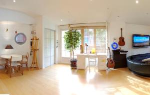 a living room with a table and a room with guitars at Maison de 3 chambres avec jardin clos et wifi a Montlucon in Montluçon