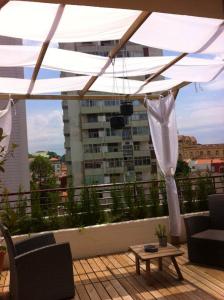 a rooftop patio with a white canopy and a table at 2 bedrooms appartement with lake view furnished balcony and wifi at Porto in Porto
