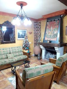 a living room with a christmas tree and a fireplace at Mountain House in Ivanrey in Ciudad-Rodrigo +14 photos