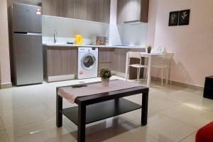 a kitchen with a washing machine and a table at HB1512- Hyve Studio unit, Lake view, Cyberjaya, Free Wi-Fi, Free Parking, Netflix,Pool, 3038 in Cyberjaya