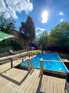 a wooden deck with a swimming pool and a wooden deck at 3 bedrooms villa with private pool enclosed garden and wifi at Osteria delle Noci in Osteria Delle Noci