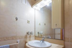 a bathroom with a sink and a mirror at Elegant Apartment in Lloret de Mar, 85 m² with Pool in Lloret de Mar +11 photos